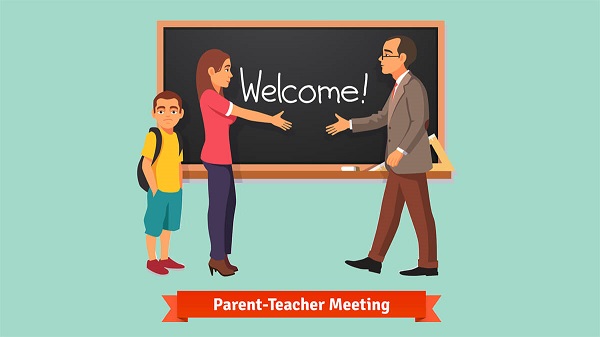 In a classroom, a woman talking to the teacher. Their child is standing behind them. On the board, Welcome to Parents Teacher Meeting is written.